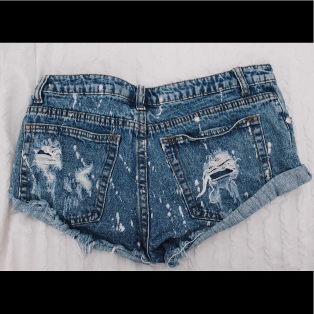 used distressed jean shorts w/ paint splatter